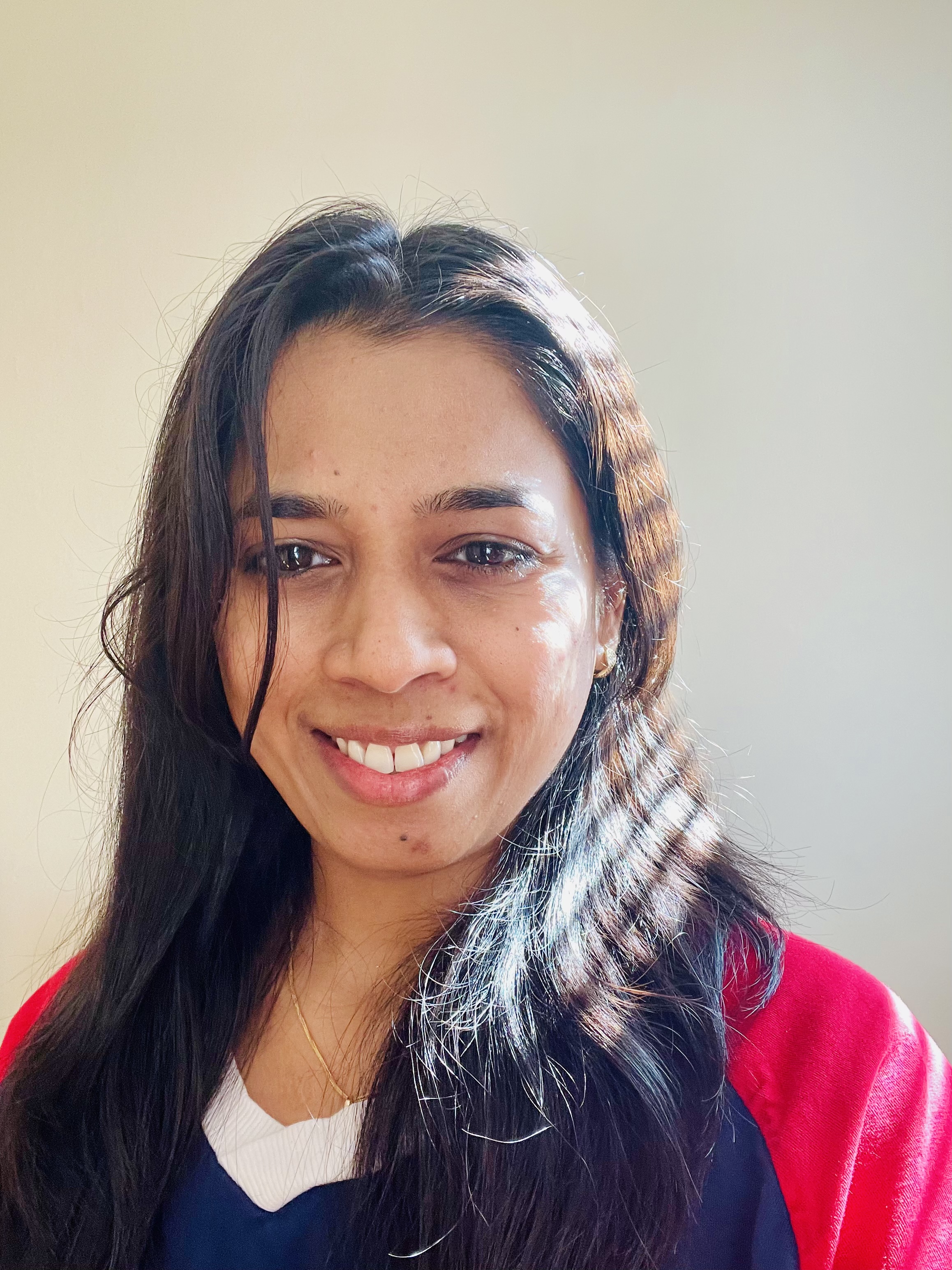 Neha Chaudhari smiling in natural light